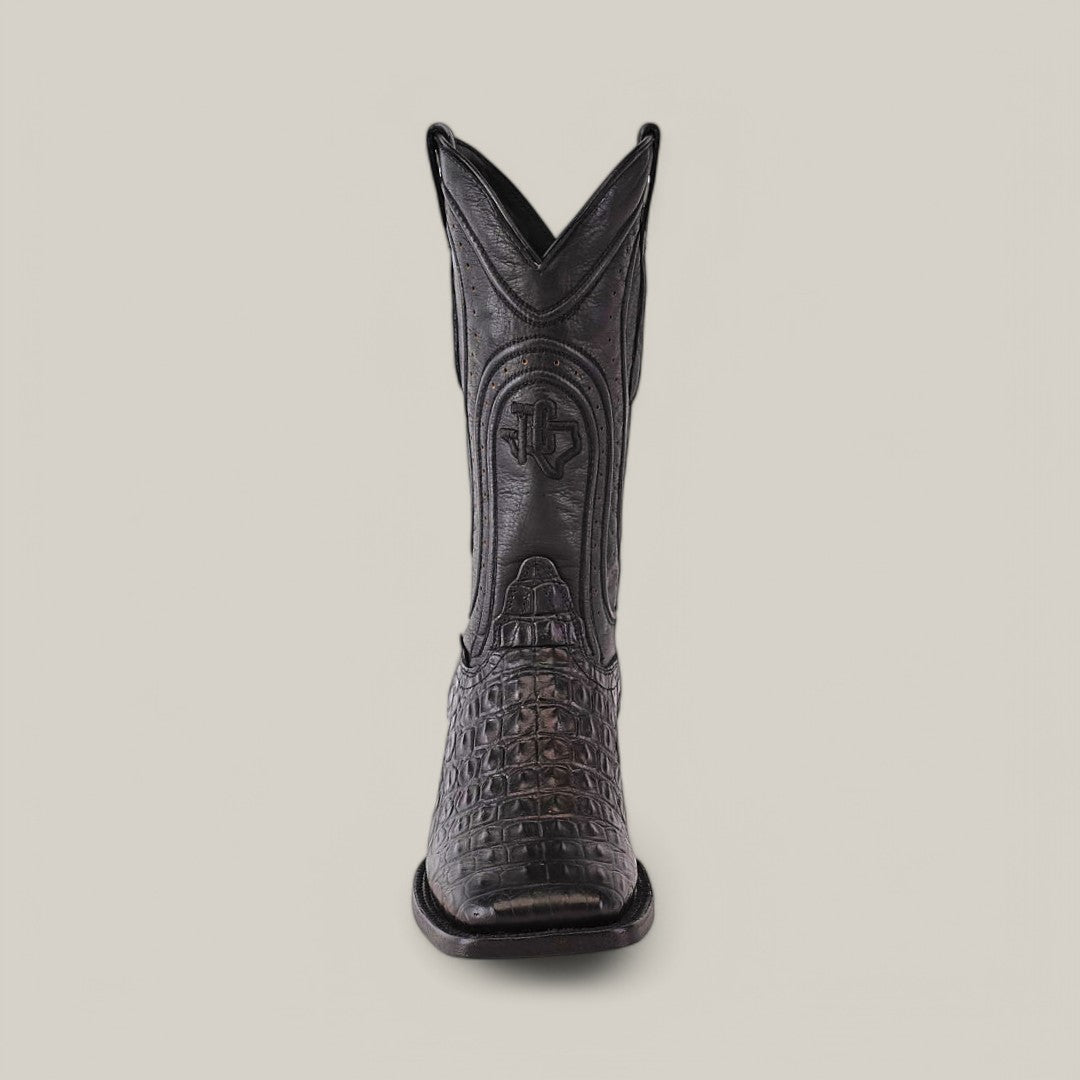 The Alligatoar Horn Back Print Black - Square Toe boot is front-facing, showcasing exquisite leather craftsmanship with a square toe and crocodile pattern. Decorative stitching highlights its elegance against a plain backdrop.