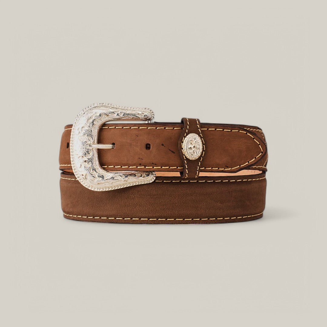 The Brown Plain Belt - Silver Buckle features a brown leather design with decorative stitching and an ornate silver buckle, coiled against a plain light backdrop for a versatile look.