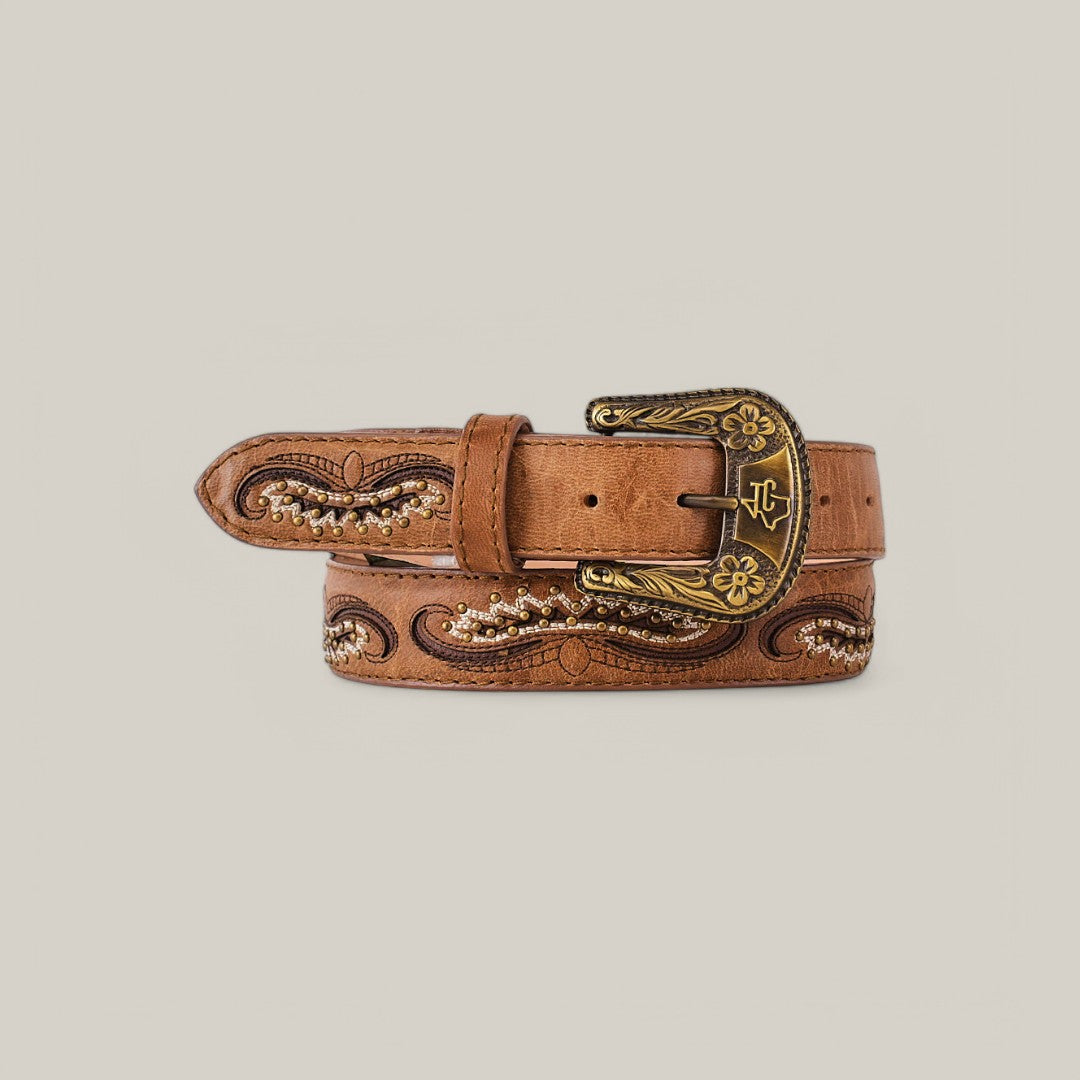 The Corella Fawn Belt - Texas Buckle is a brown leather belt embroidered with intricate floral designs and a metal buckle featuring engraved details. This elegant womens accessory is rolled to highlight its craftsmanship, ideal for those seeking sophisticated belts.