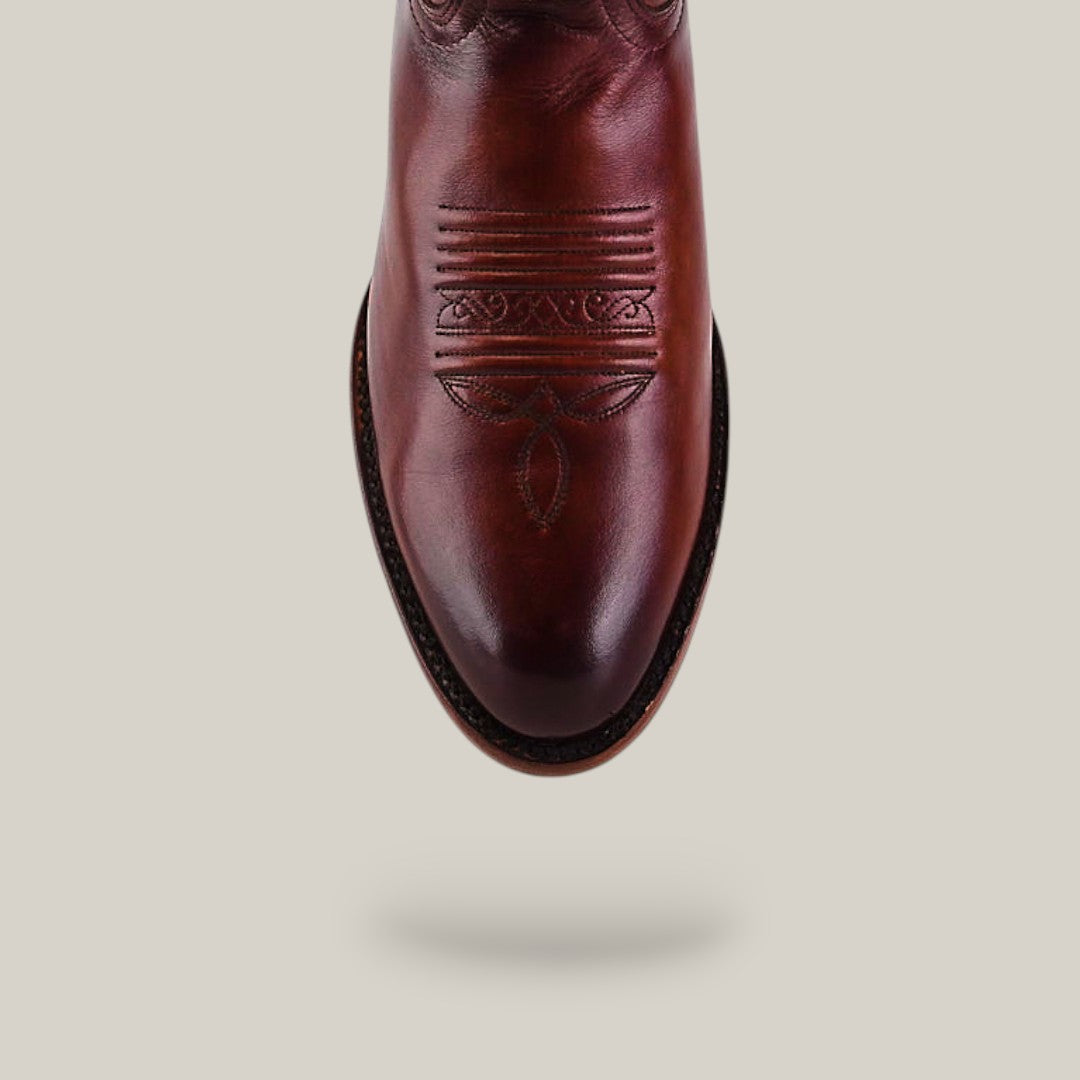 A top-down view of the Wyatt - Camel - Roper Toe boot in brown cowhide with decorative stitching, highlighting premium leather and expert craftsmanship against a plain light background.