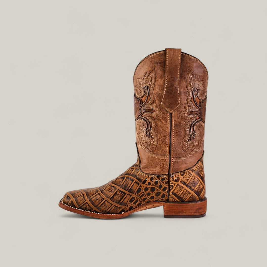 The Jonh - Orix - Square Toe boot is a single brown cowboy boot made from premium leather, with intricate shaft stitching and a textured crocodile-patterned lower half, shown on a plain beige background.