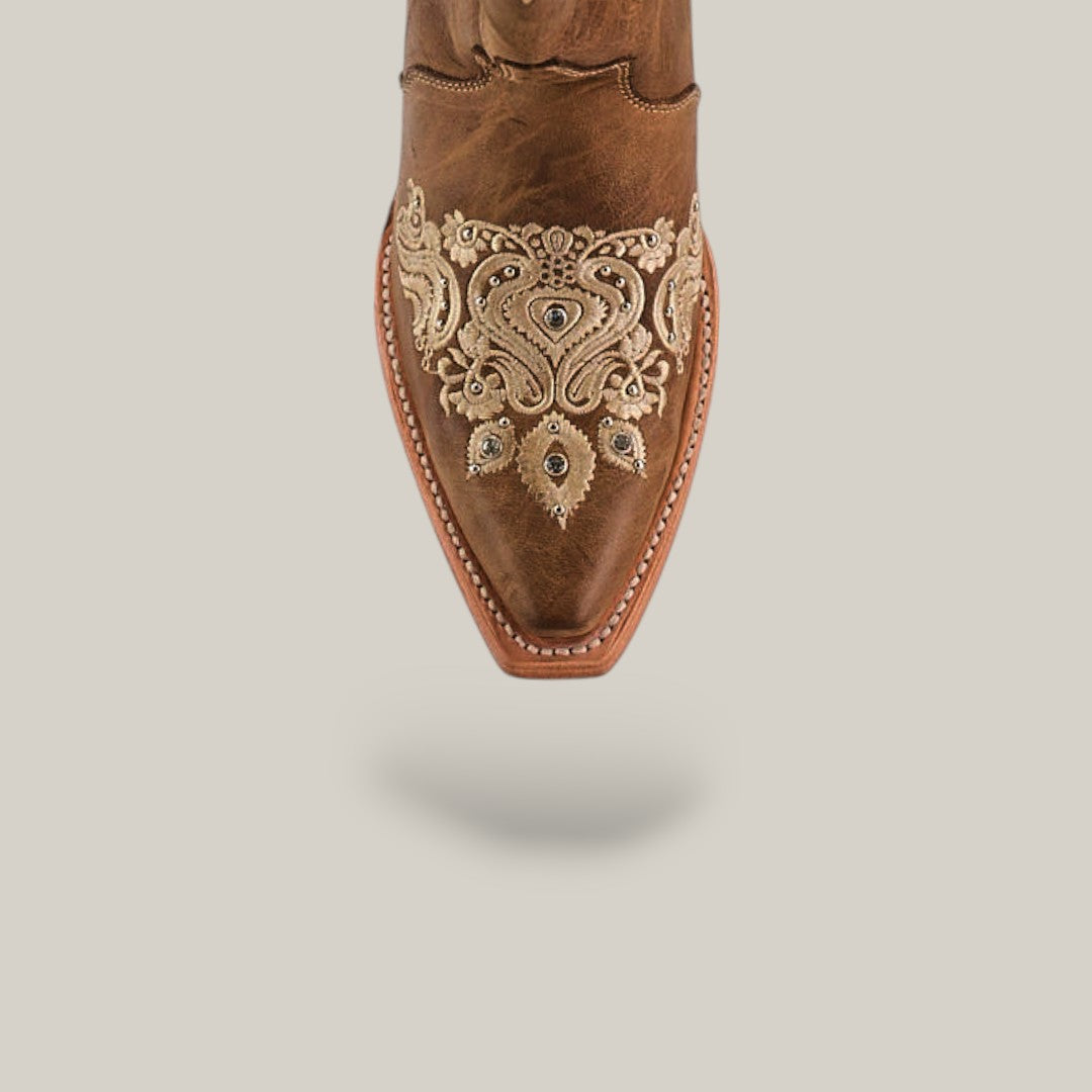 Top view of the Roxanne Crystals Tabaco tall shaft womens boot, featuring brown leather with beige embroidery and decorative patterns on the snip toe, set on a neutral background with a soft shadow underneath.