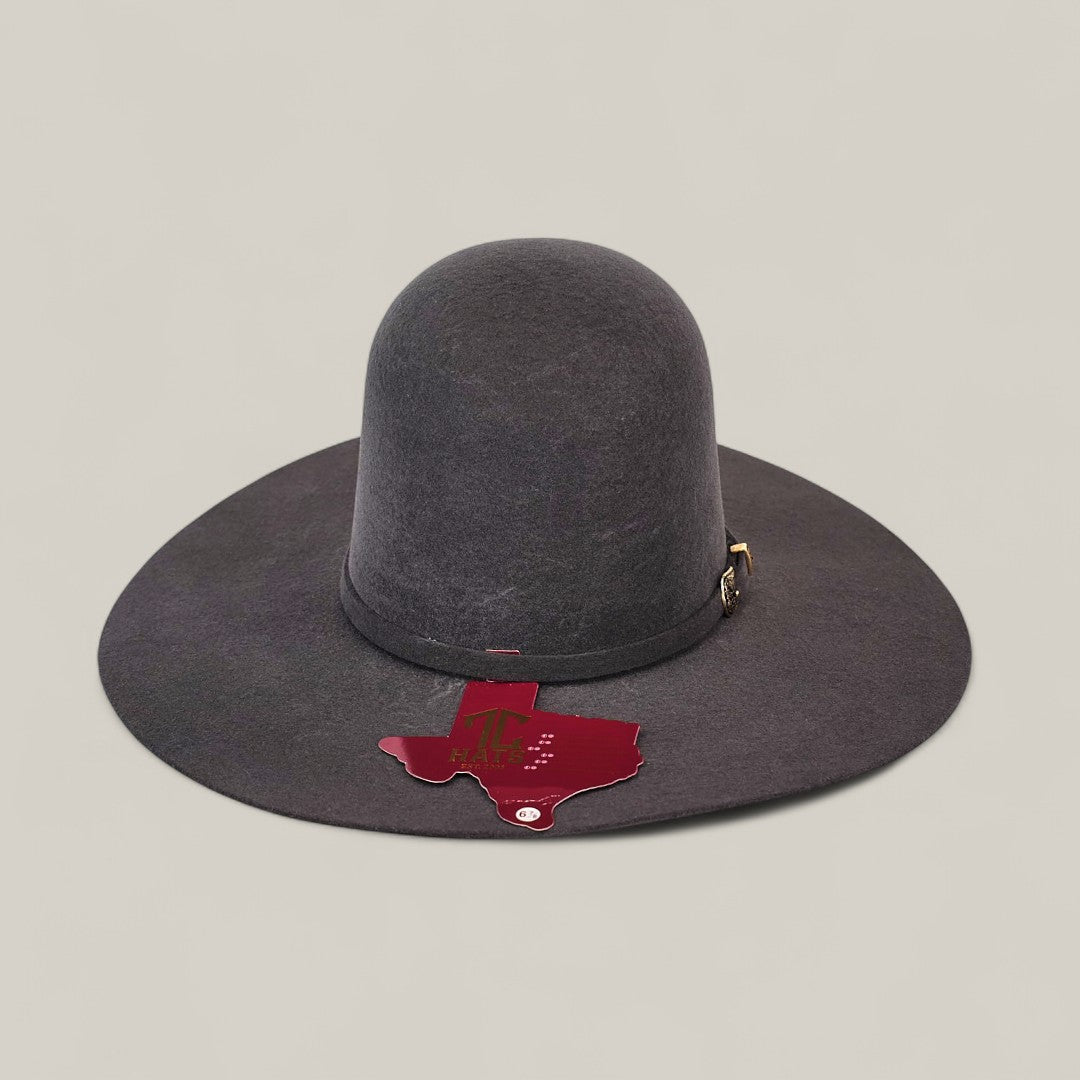 The 4X Gray - TC Hat is a wide-brimmed, dark gray open crown Texana Western hat featuring a gold buckle, decorative band, and a Texas-shaped A&M tag representing Texas A&M University, displayed on a light background.