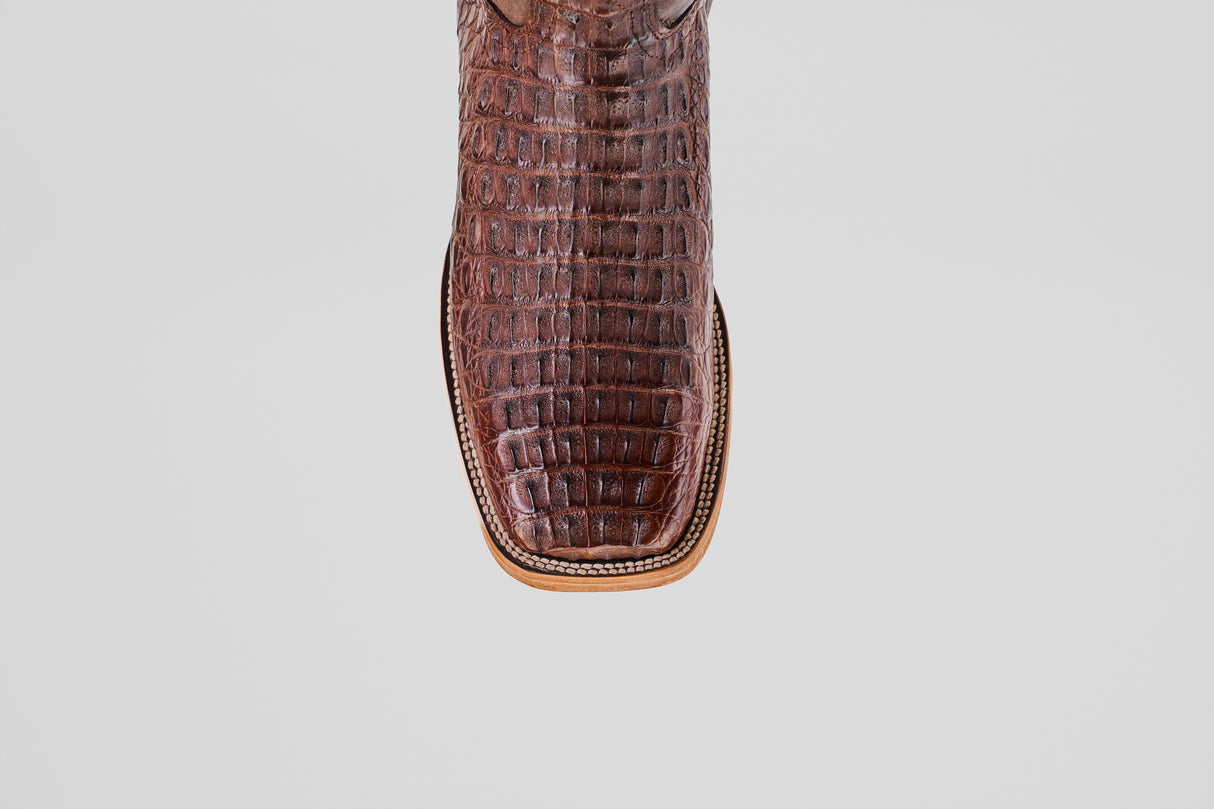 A close-up of the Exotic Caiman Horn Back - Brown - Square Toe boot shows its luxurious, exotic texture and distinctive square toe against a plain white background.