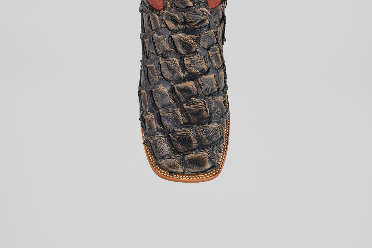 Close-up of the toe of the Butch - Caramel - Square Toe cowboy boot featuring decorative stitching and a textured pattern, crafted from luxurious Pirarucu leather for an exotic look.