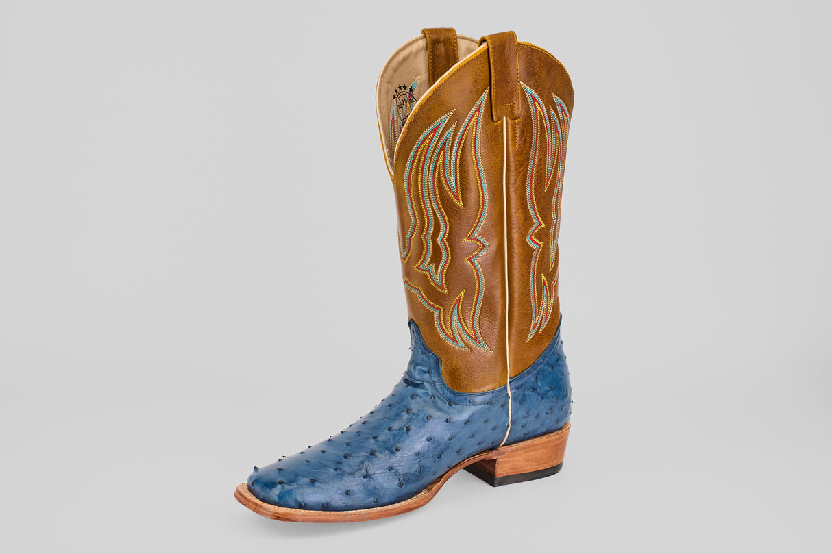 The Ridge - Blue - Square Toe boot from the Platinum Collection showcases a brown leather shaft with yellow stitching and a blue textured ostrich foot—an outstanding Exotic Boot—displayed on a plain white background.