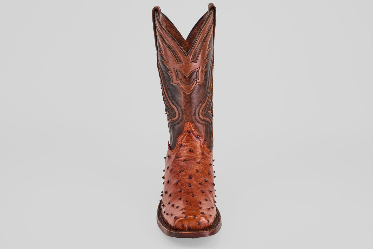 The Exotic Ostrich - Brandy - Rodeo Toe boot, crafted from genuine ostrich leather with decorative shaft stitching and textured spiked foot details, stands upright and forward on a plain light background.