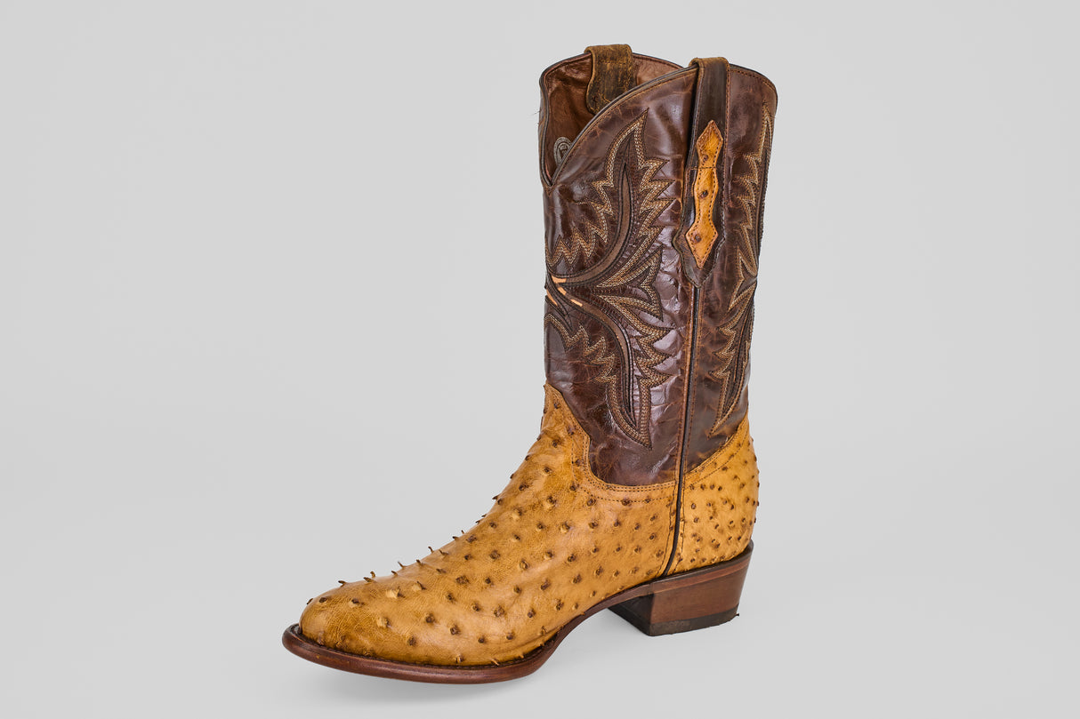 The Exotic Full Quilt Ostrich - Paja - Round Toe features brown leather and light tan ostrich skin with signature raised quills and decorative stitching, presented on a plain gray background.
