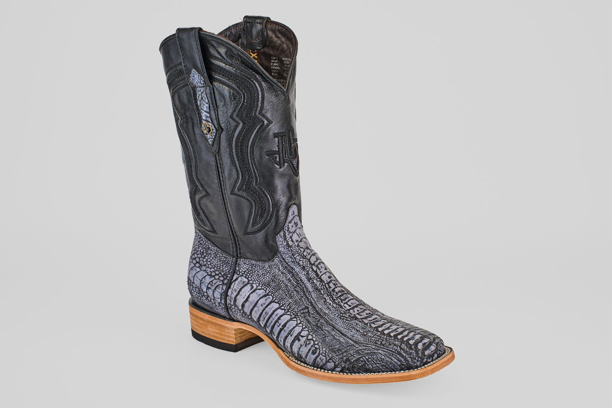 The Austin Leg - Blue Jean - Square Toe is a men’s cowboy boot with a black leather upper and textured gray-black lower, featuring ostrich-style patterning, brown stacked heel and sole, plus decorative stitching on the shaft.