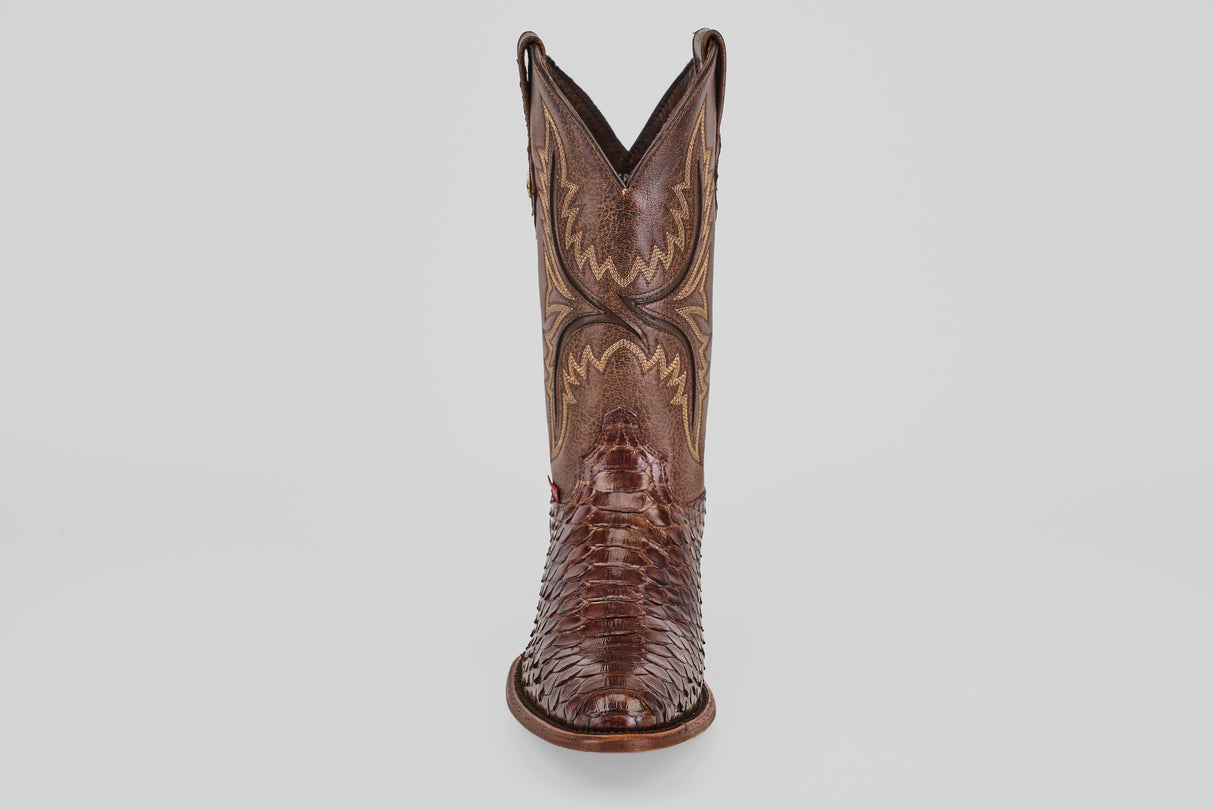 A single Tanner - Brown - Round Toe cowboy boot with detailed shaft stitching and a textured foot is shown from the front against a plain light background.