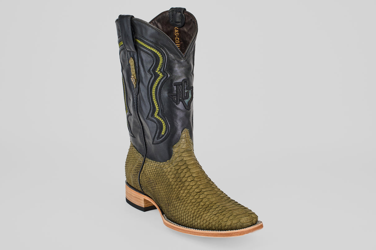 The Tanner - Green Jungle - Square Toe is a western boot featuring a green, scaly python leather foot, black leather upper with yellow stitching and designs, and a light brown wooden heel, shown on a plain light background.