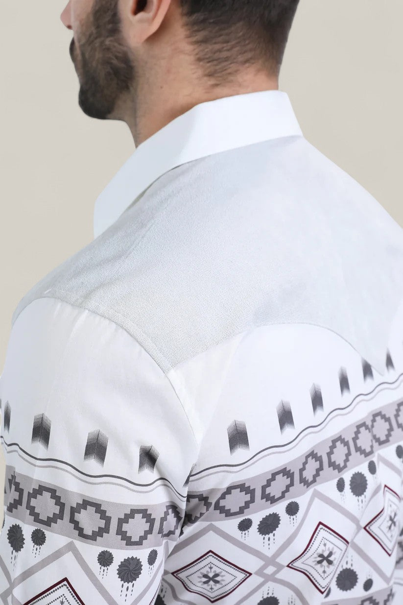 A man with a short beard, seen from behind and slightly to the side, wears the Mens Western Modern Fit Cotton/Spandex Long Sleeve White Shirt with Snaps (WPL10751), featuring grey and black Southwestern-inspired geometric patterns.