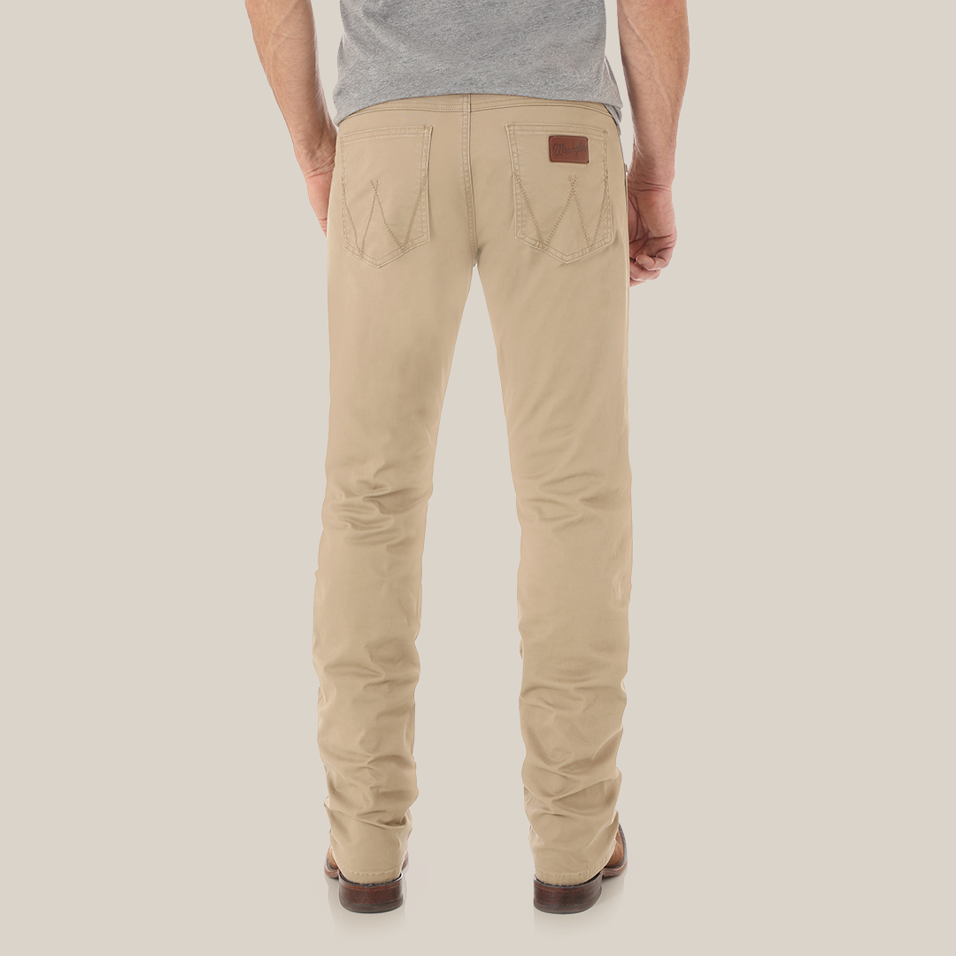 Someone is wearing Mens Wrangler Retro Slim Fit Straight Leg Pants from 1088MWZFN, styled with a brown belt and boots. The upper body features a gray T-shirt against a simple white background.