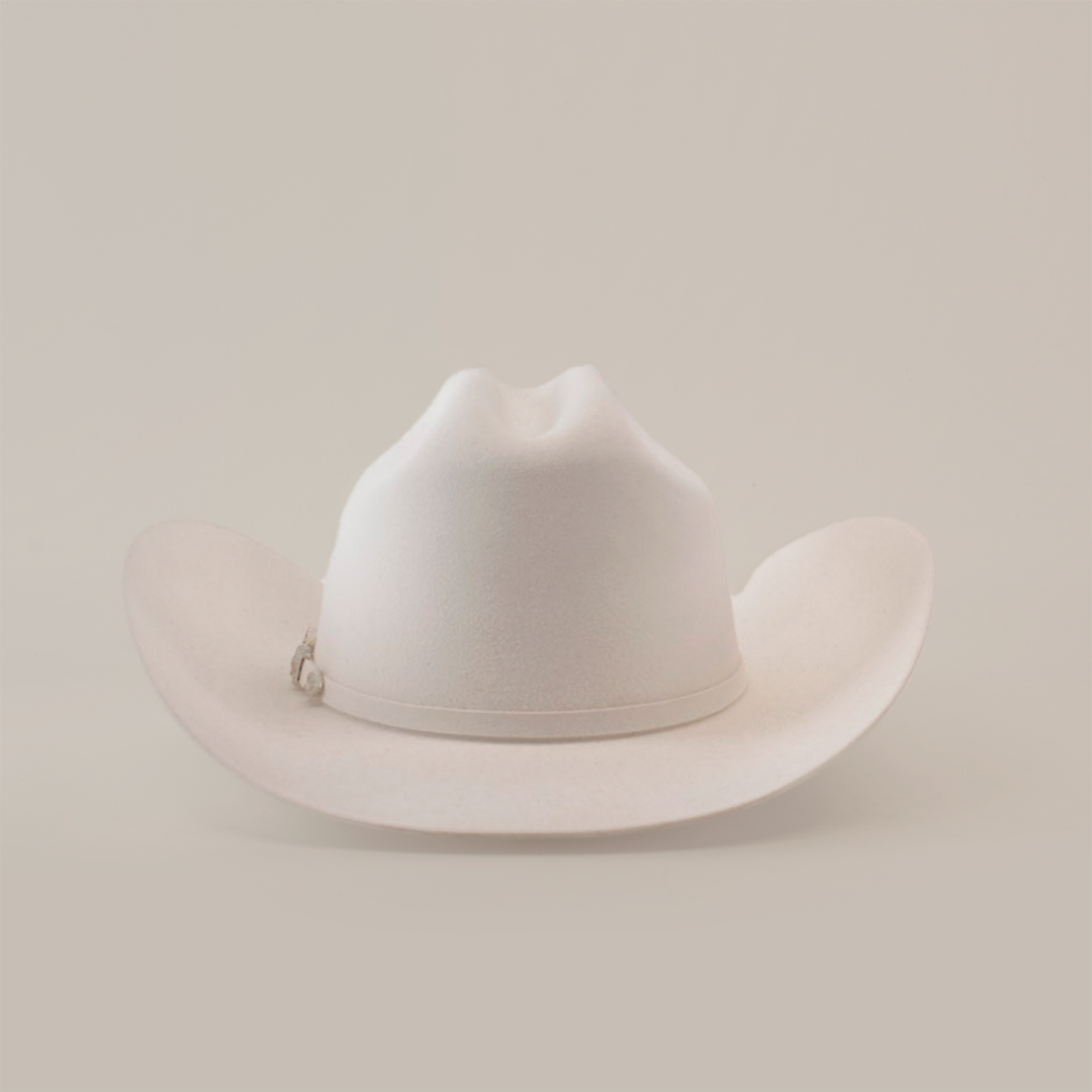 The 6X Real White is a luxurious cowboy hat, skillfully handcrafted by artisans, featuring a wide brim and creased crown set against a plain white background.