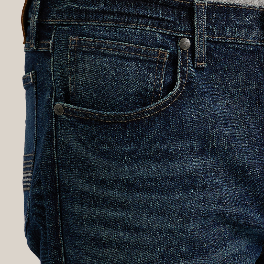 Close-up of someone wearing Wrangler 20X Sunnybrook Dark Wash Extreme Relaxed Straight Stretch Denim Jeans (112344469) and a gray shirt, focusing on the premium denims side, front pocket, and belt loops.