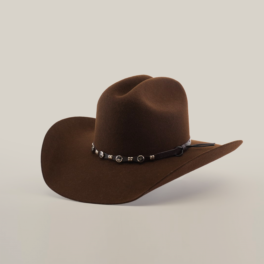 The 6X Dallas Brown felt hat embodies Western elegance, featuring a brown hue, curved brim, and a black band with silver conchos. Made from quality sheep wool and set against a plain white background, it captures frontier spirit.