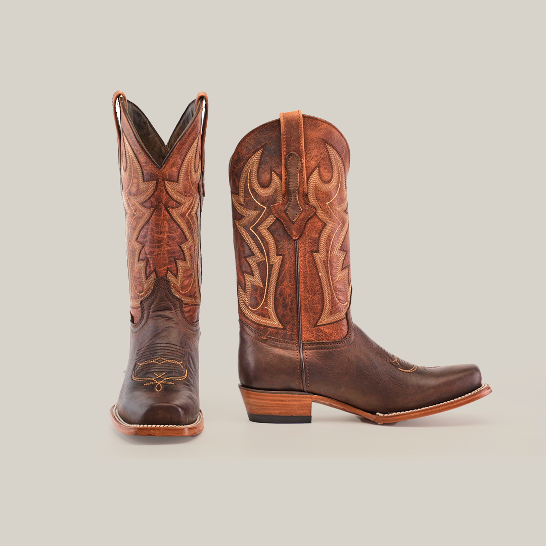 These premium Fresno Chocolate cowboy boots in cowhide brown feature tan stitching and patterns, with a side view of the left boot and a Wide Cutter Toe on the right. Both have wooden heels and pointed toes, offering elegance with rugged charm.