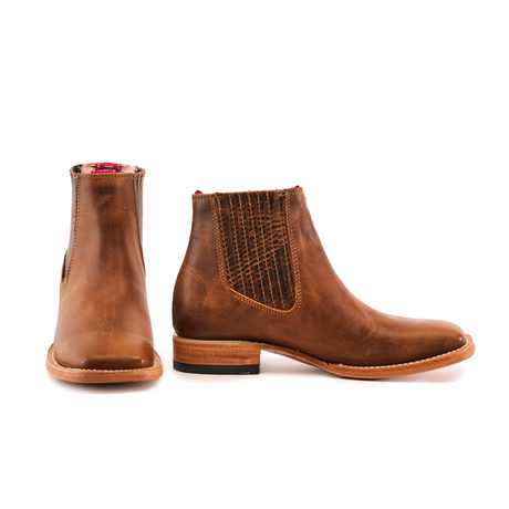 Two Avejentado Honey square toe leather ankle boots are shown, one facing forward and the other in profile. Featuring elastic side panels with texture, a wooden sole, and contrasting red lining for flair—perfect for any relaxed cowboy look.