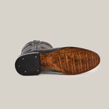 The Rush Black - Roper Toe cowboy boot is displayed on its side against a white background, highlighting the intricate brown crocodile-patterned sole that captures the Western spirit.