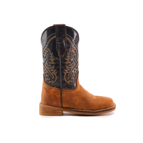 The Cater Honey Square Toe is a cowboy boot made from cowhide leather, with a brown leather foot and an ornate darker stitched shaft. It features classic western styling, low heel, and pull tabs.