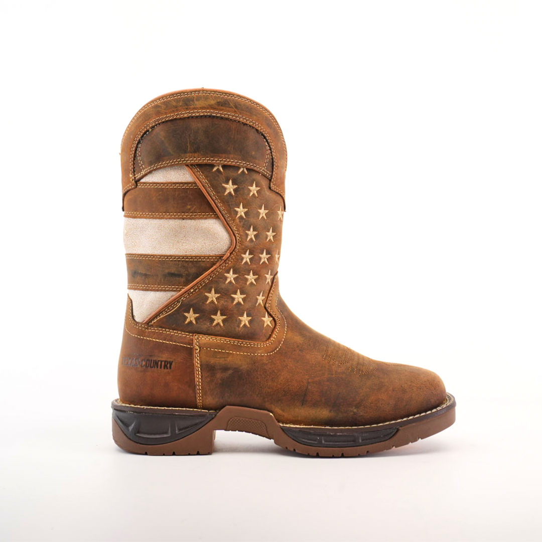 The White Tan US Flag - Waterproof - Soft Toe boot is handcrafted from cowhide leather, showcasing an American flag design with tan and white stripes and stars on a dark background, complete with a thick, durable dark brown sole.