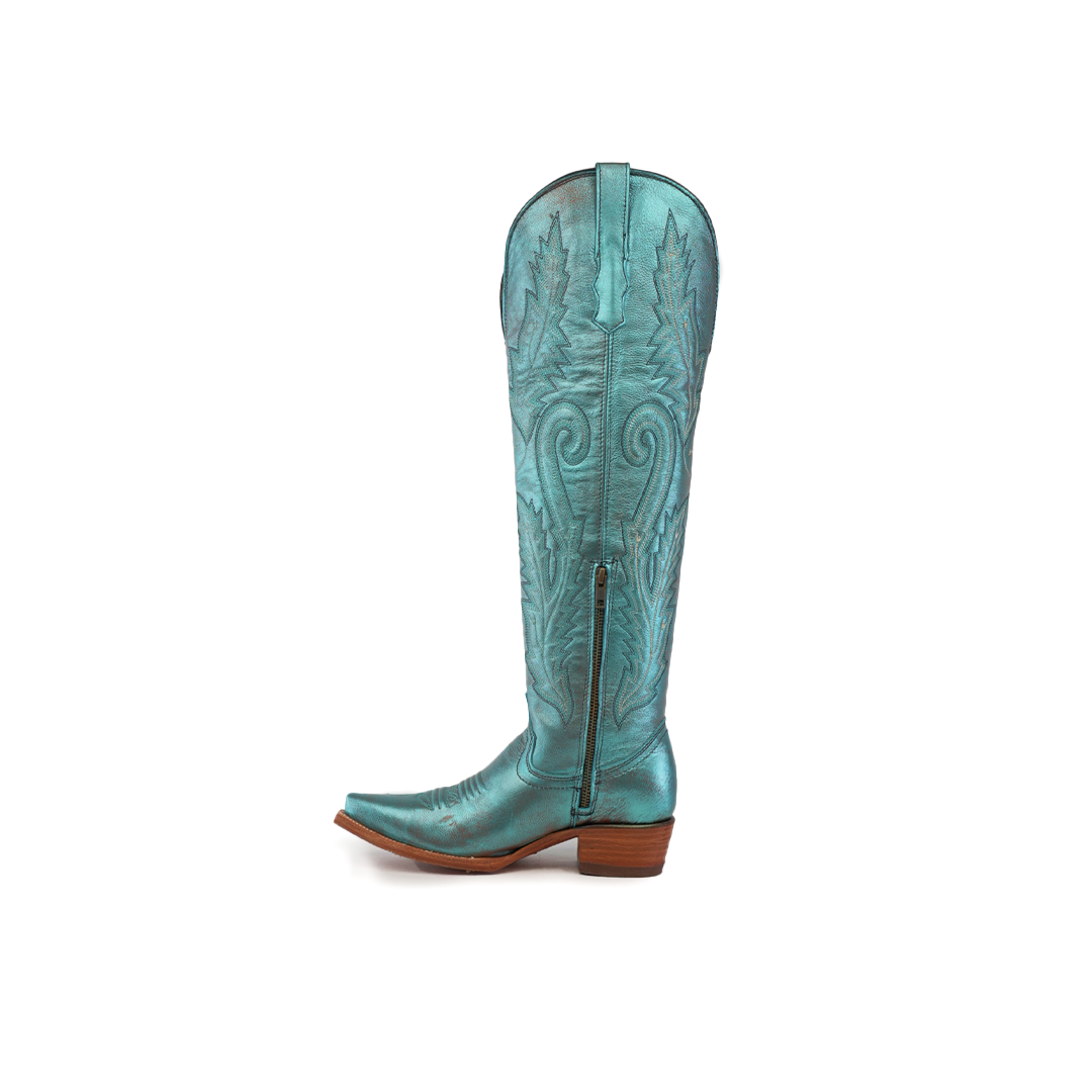 Introducing the Brittany Rustic Ceramic Tall Shaft Snip Toe Boot: a turquoise cowboy boot with leaf patterns, pointed toe, low brown wooden heel, genuine leather sole, side zipper closure, and decorative stitching.