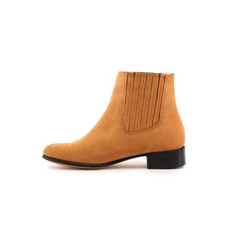 The Prime Suede Honey Round Toe ankle boot features a smooth tan finish with elastic side panels and a low black heel. Displayed in side profile against a white background, it highlights its elegant design.