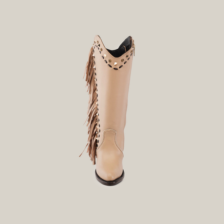 The Praga Fringe Tall Shaft Cream - J Toe boot, from our handcrafted Platinum collection, showcases tan leather with fringe and decorative cutouts. Its pointed toe elegantly stands out against a plain white background.