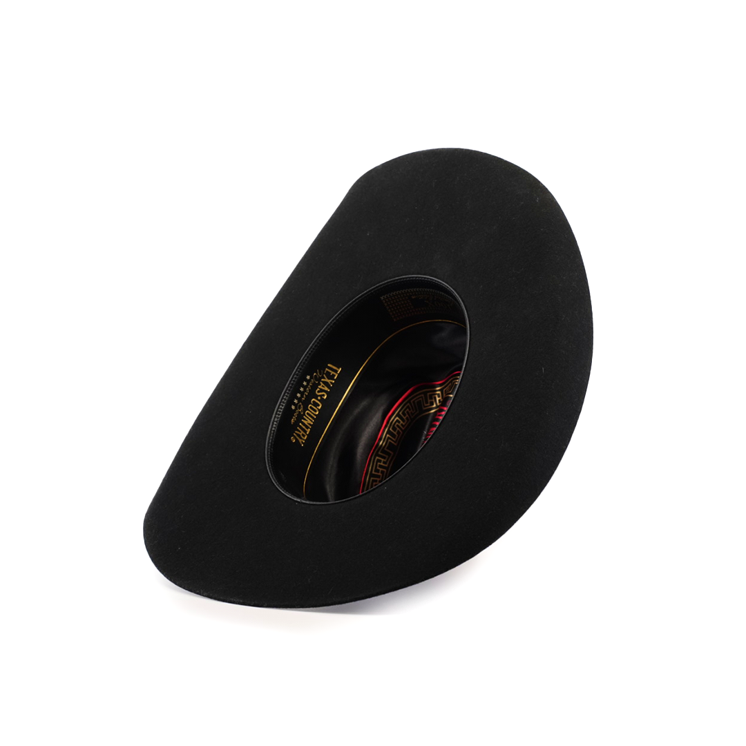 A 6X Dallas Black hat, crafted from sheep wool with a smooth surface and wide brim, lies showcasing its interior. The lining boasts a red and gold pattern alongside the brand label, highlighting Western sophistication.