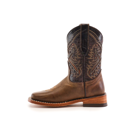 The Ranch Camel Square Toe boot, made from cowhide leather, features intricate shaft stitching and patterns, a wooden heel, and a rounded toe. Displayed on a white background, it exudes western elegance.