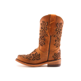 The Cosala Honey - Snip Toe cowboy boot features a side view in brown genuine leather with floral embroidery, a medium heel, and a rounded toe. Leaf and flower patterns adorn the shaft and foot against a crisp white background, offering a classic western look.