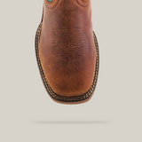 The Rustic Turquoise Brown boot, made from premium cowhide leather, combines a brown foot with a vibrant turquoise shaft featuring intricate stitching, set against a plain white backdrop. Its waterproof and includes a composite toe for added protection.