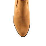 A top view of the Prime Suede Honey Round Toe boot showcases its rounded toe, minimal stitching, and sleek black sole edge against a white background, exuding a simple yet elegant design evocative of classic cowboy scenes.