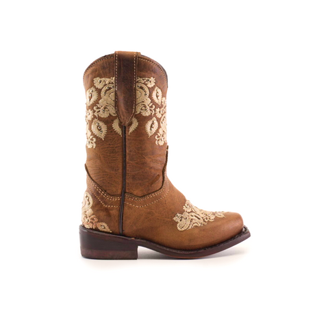 The Martey Crystals Sahara - Snip Toe is a brown cowboy boot adorned with detailed white floral embroidery and crystal embellishments on the shaft and toe, seen from the side. It has a low heel and a rounded toe.