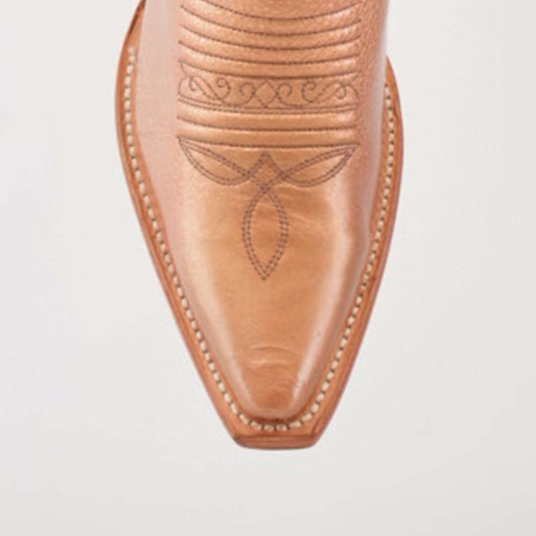 Close-up of the snip toe of a brown Taylor Rose Gold tall shaft cowboy boot, showcasing intricate swirl and leaf stitch patterns against a white background. The rose gold accents enhance its timeless elegance.