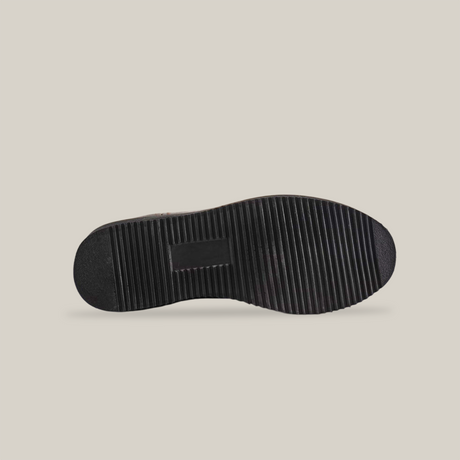 The image displays the sole of a black shoe, similar to the Brown Roper - Laredo Sole - Composite Toe. It features a ridged pattern for traction with horizontal grooves across the surface, highlighting exceptional craftsmanship