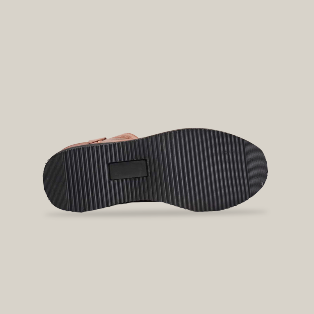 The image showcases the Brandy Roper - Tractor Sole - Composite Toe, demonstrating handcrafted excellence with a rugged tread. The black soles deep grooves and cross patterns ensure traction, while the plain white background highlights its premium design.