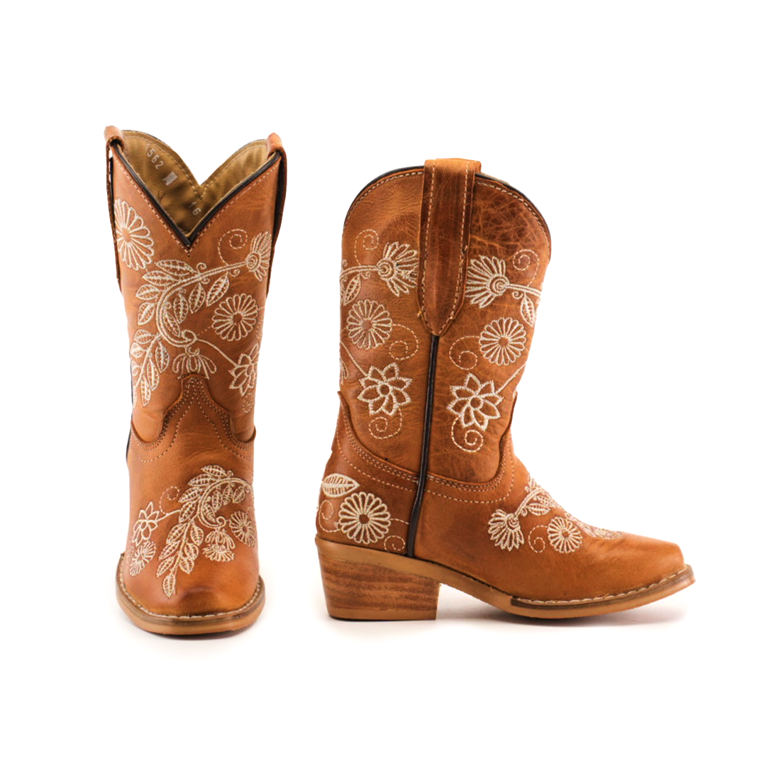 The Rama Honey - Snip Toe boots, crafted from genuine leather, feature beige floral embroidery. These brown cowboy boots have a wooden heel with intricate flower and leaf designs. One boot is forward-facing while the other is turned to the side, perfect for little girls footwear.