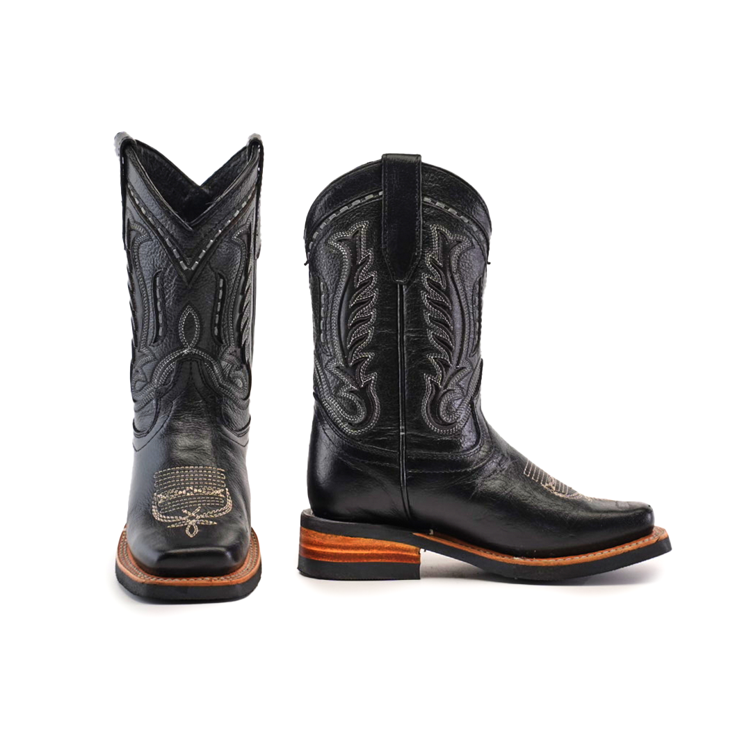 The Barcelona Black Lustre Rodeo Toe boots feature premium cowhide leather, decorative stitching on the shafts and toes, a sleek square toe design, and wooden soles. One boot is positioned forward while the other is turned aside.