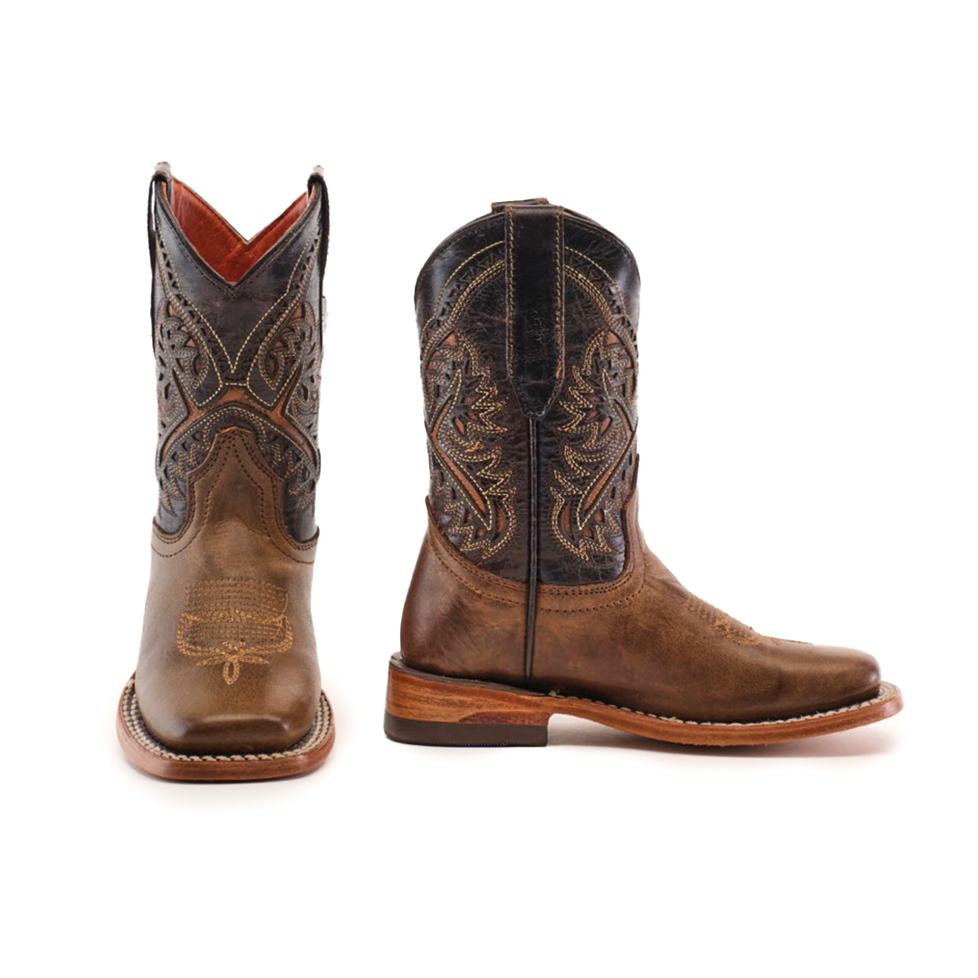 The Ranch Camel Square Toe cowboy boots, crafted from brown cowhide leather, feature intricate stitching and a decorative shaft pattern. With square toes and stacked heels, they exude western elegance. One boot faces forward while the other is side-facing.