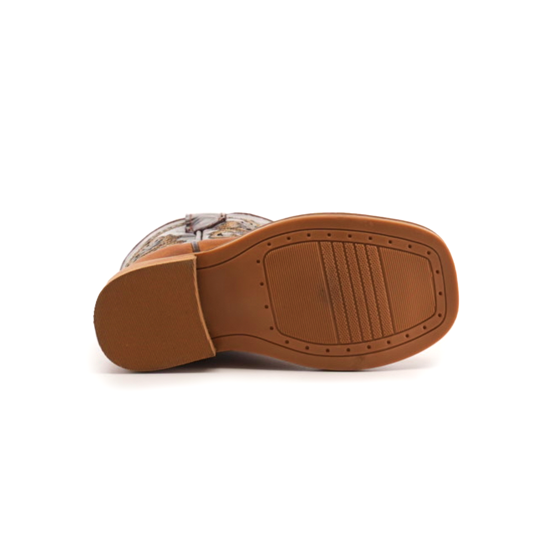 A bottom view of the Cater Honey Square Toe shoe features a rectangular cowhide leather sole with a smooth finish showcasing intricate texture patterns, while the partially visible upper boasts a handcrafted, vibrant design.