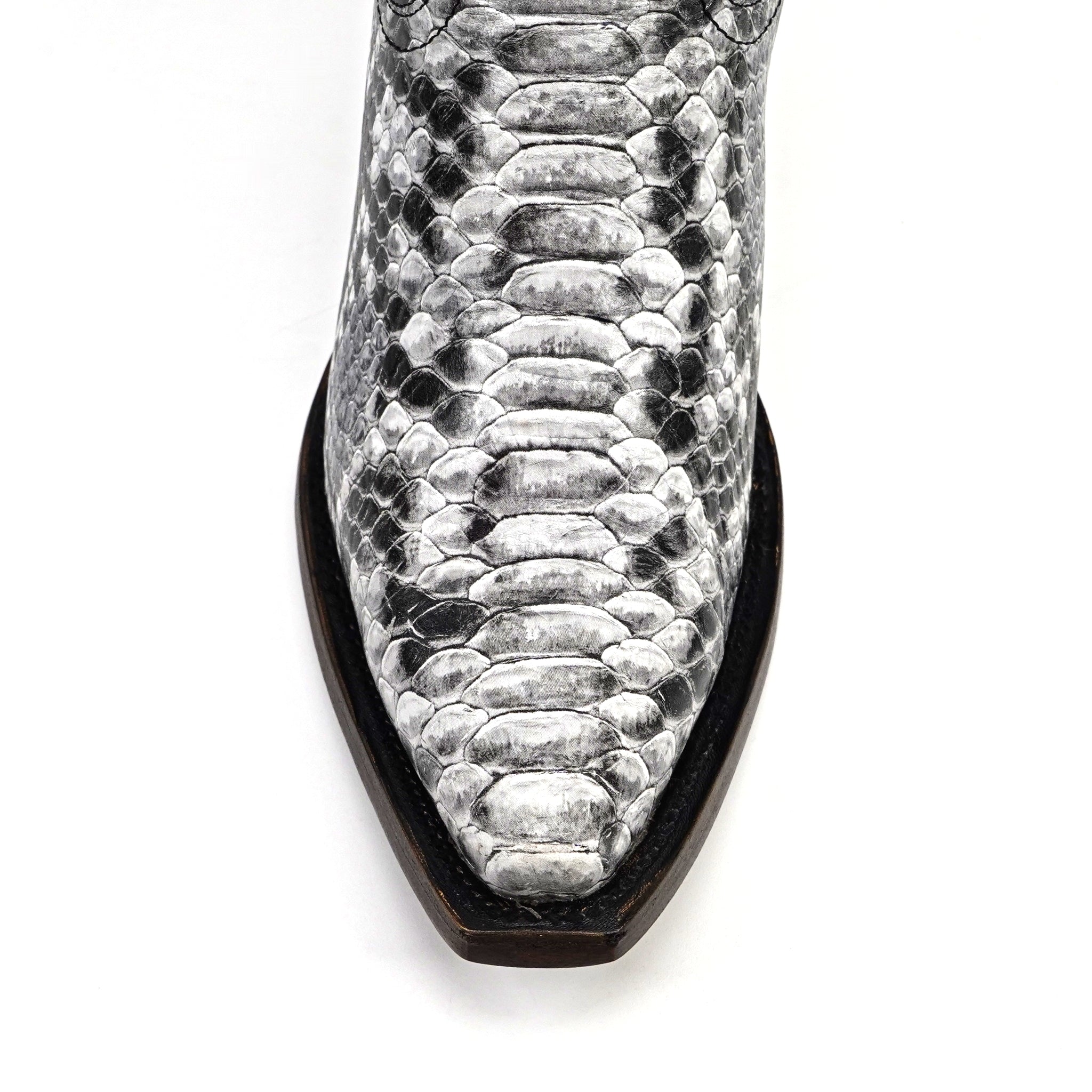 Close-up of a snake skin-patterned boot on a white background