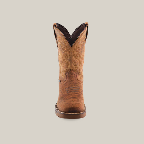 One handcrafted Tan Brown Rough out boot with intricate stitching is shown front view against a white background. It features swirling patterns on premium cowhide leather with a rounded composite toe, slightly darker sole, and waterproof design.