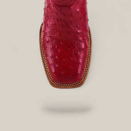 A close-up, top view of the Exotic Full Quilt Ostrich - Red - Square Toe boot, featuring detailed stitching and a square toe design, set against a light gray background.