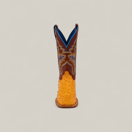 The Exotic Full Quilt Ostrich - Buttercup - Square Toe boot from the Platinum Collection features a yellow ostrich leather foot, brown upper, blue lining, and detailed blue and yellow stitching, shown upright on a plain light background.