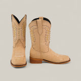 The Orion Suede Bone - Square Toe Kids Boots feature tan premium suede, detailed white and yellow stitching, wooden heels, and pointed toes, showcased against a simple light background.
