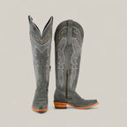 The Celine Gray - Tall Shaft - Snip Toe womens boots feature gray suede, decorative stitching, wooden heels, pointed toes, and a side zipper, shown against a plain beige background.