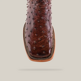 A close-up of the Exotic Full Quilt Ostrich - Brown - Square Toe boot reveals its textured raised dot pattern on ostrich leather. Photographed from above, it emphasizes craftsmanship and material against a plain, neutral background.