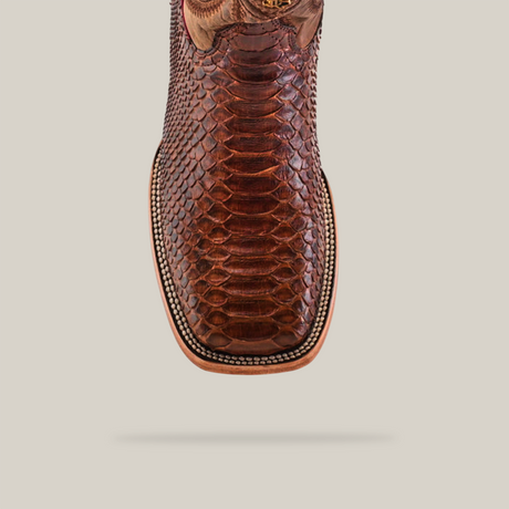 The Exotic Python - Brown - Square Toe boot features a detailed snakeskin pattern and intricate stitching, captured from the top view on a light beige background.