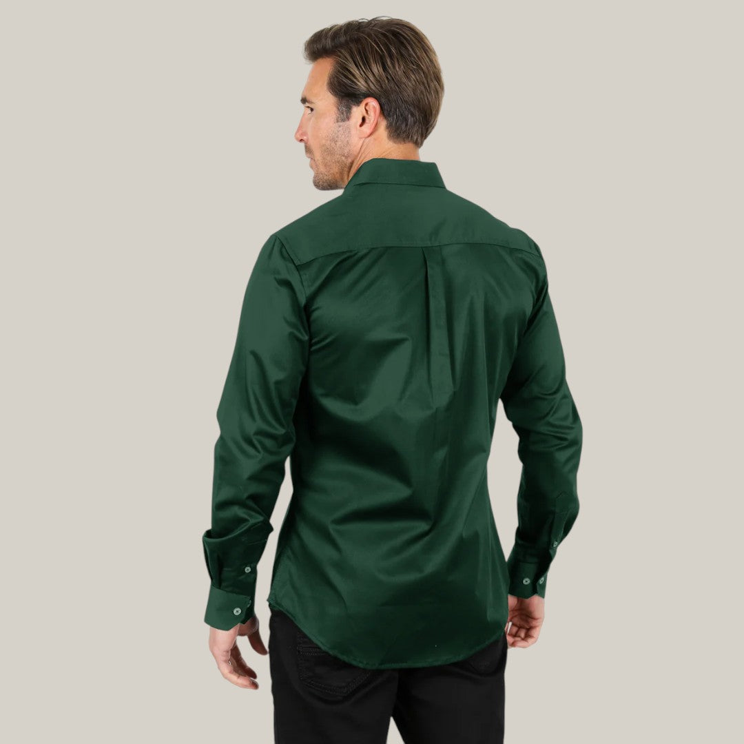 A man with brown hair, facing away, models the Mens Single Pocket Logo Modern Fit Stretch Dress Shirt in green (CTL9667) against a light gray background, paired with black pants.